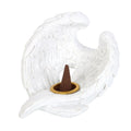 Decorative incense holder shaped like a white leaf with a brown cone on a white background