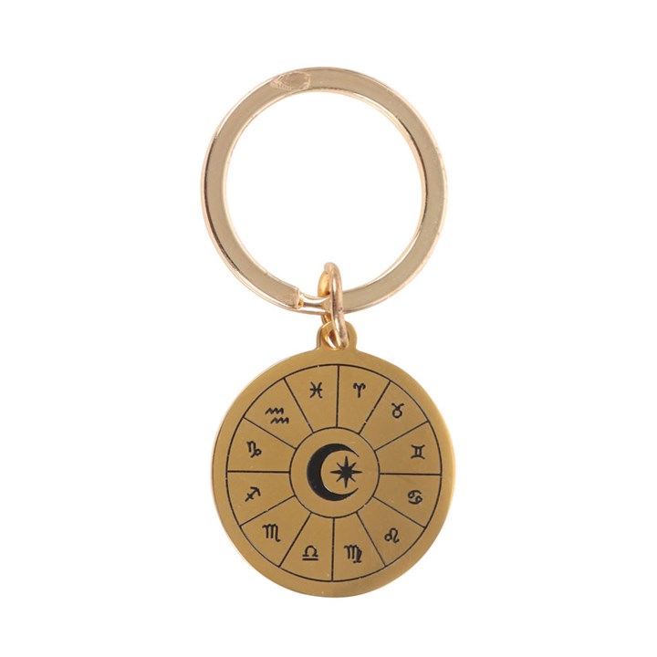 Gold keychain with zodiac symbols on a white background