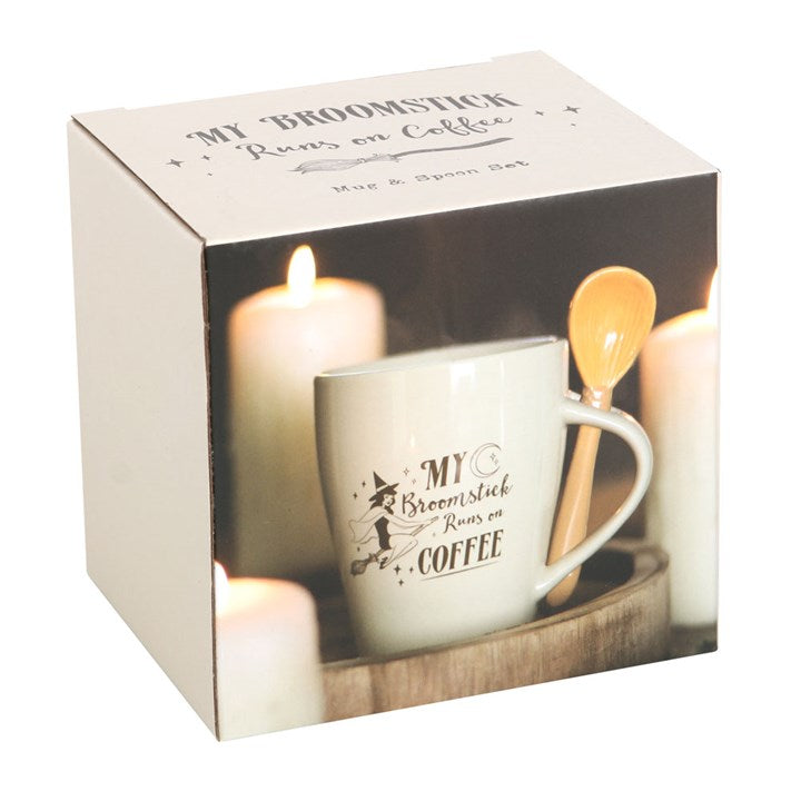 Mug and spoon set with 'My Broomstick Rides on Coffee' text in a box with candles.