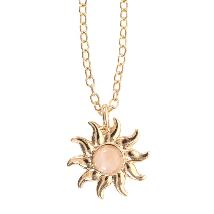 Gold sun-shaped pendant necklace with a pink center on a white background