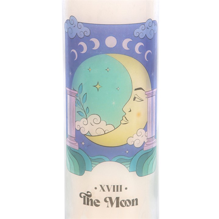 Candle with astrological design featuring a face within a moon phase circle on a white background