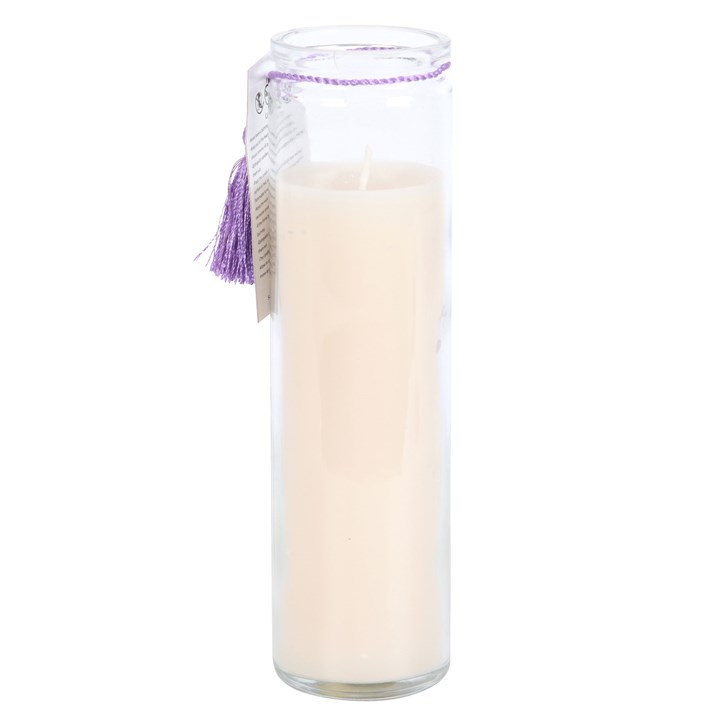 Glass candle holder with a white candle inside on a white background