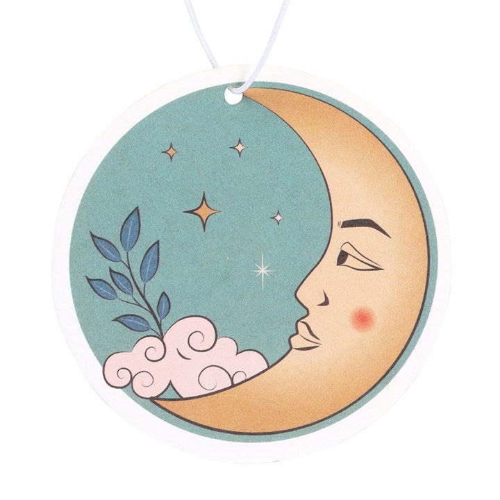Decorative moon-shaped ornament with a face, stars, and leaves on a white background