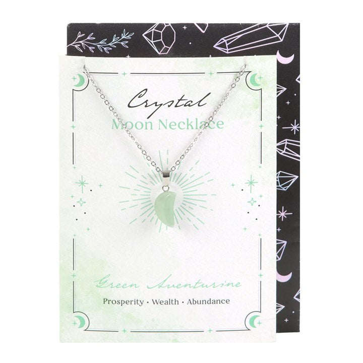 Crystal moon necklace on a decorative card with green and black design