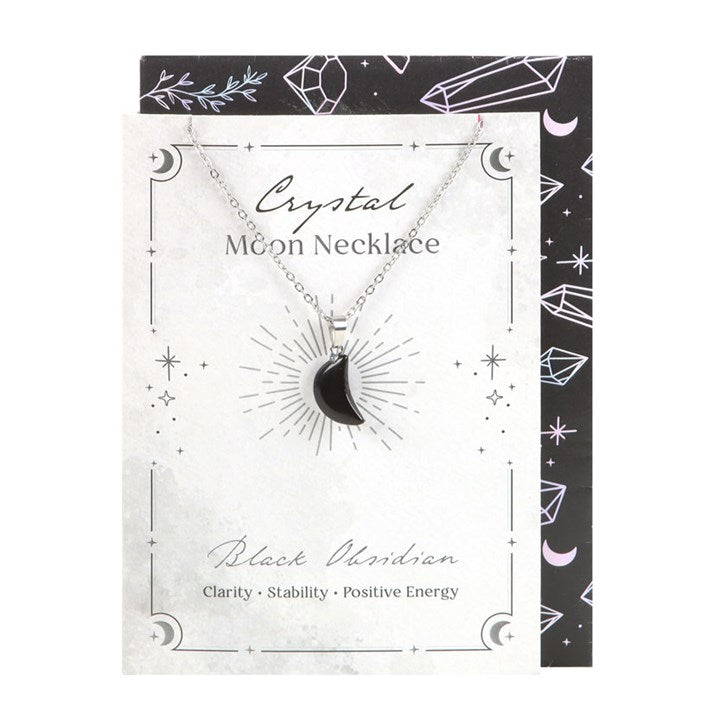 Crystal moon necklace on a decorative card with black and white design