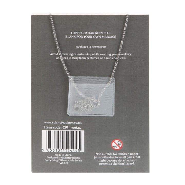 Necklace on a gray card with product details and branding.