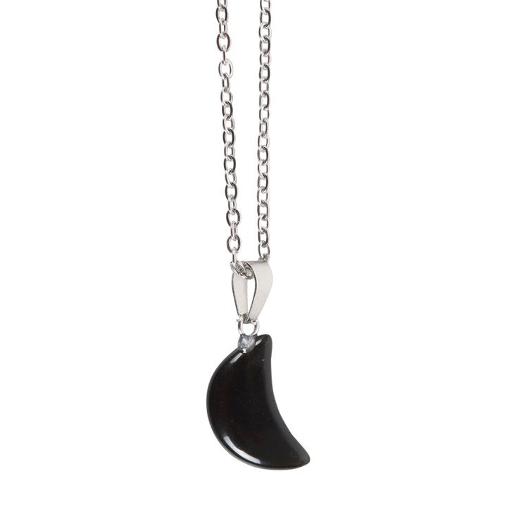 Black crescent-shaped pendant on a silver chain against a white background