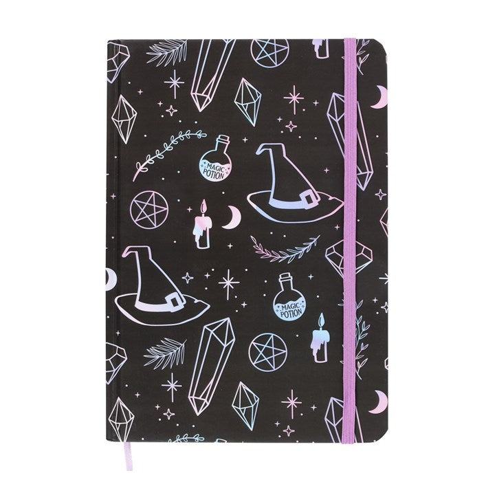 Notebook with witch hat, potion bottle, and crystal design on a black background with pink binding.