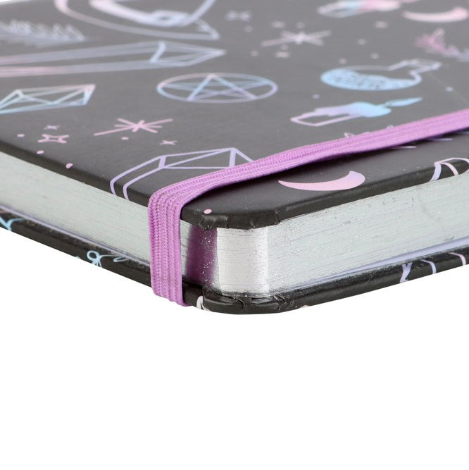 Notebook with a black cover featuring white and pink geometric designs, closed on a white background.