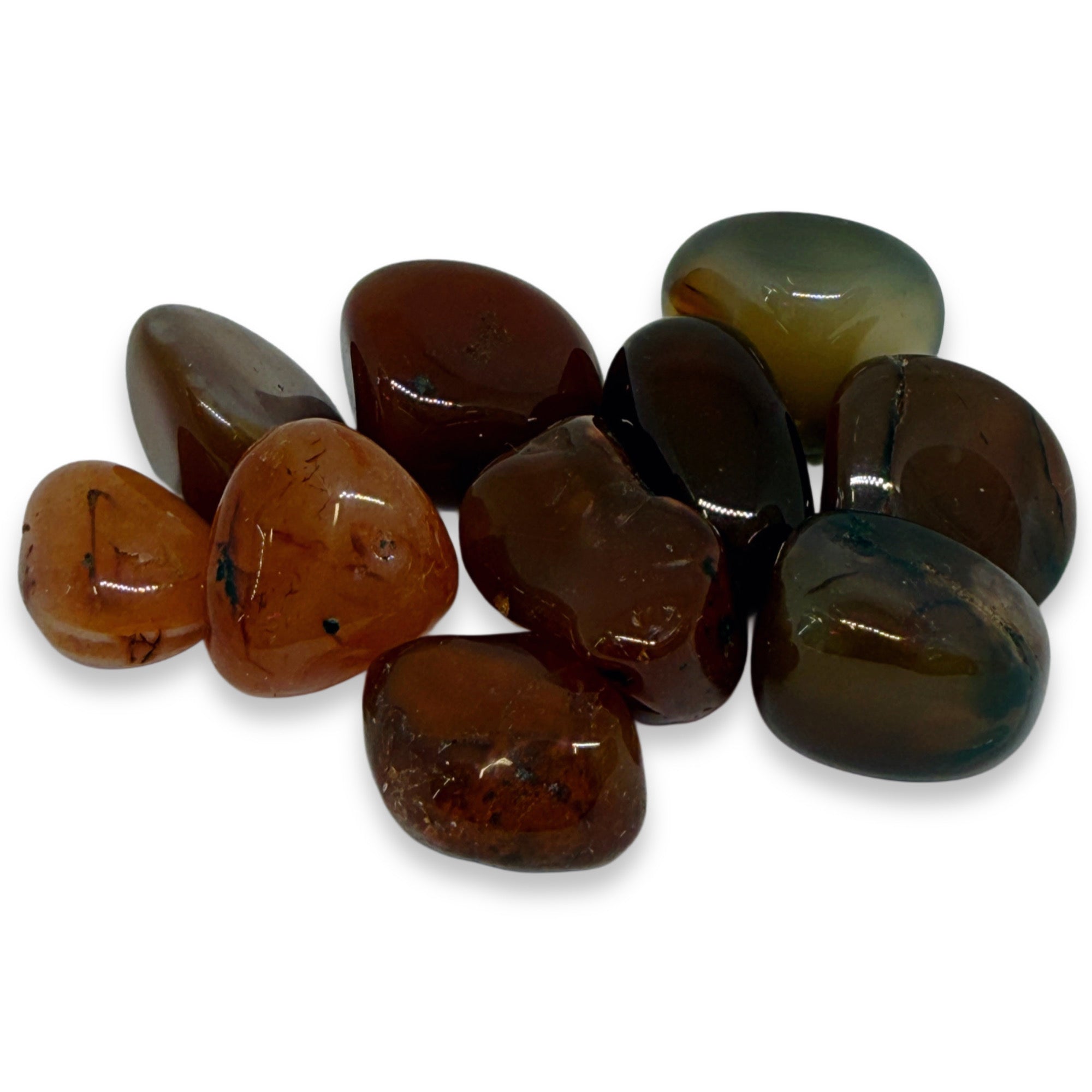 Collection of polished gemstones in various shades of brown and green on a white background