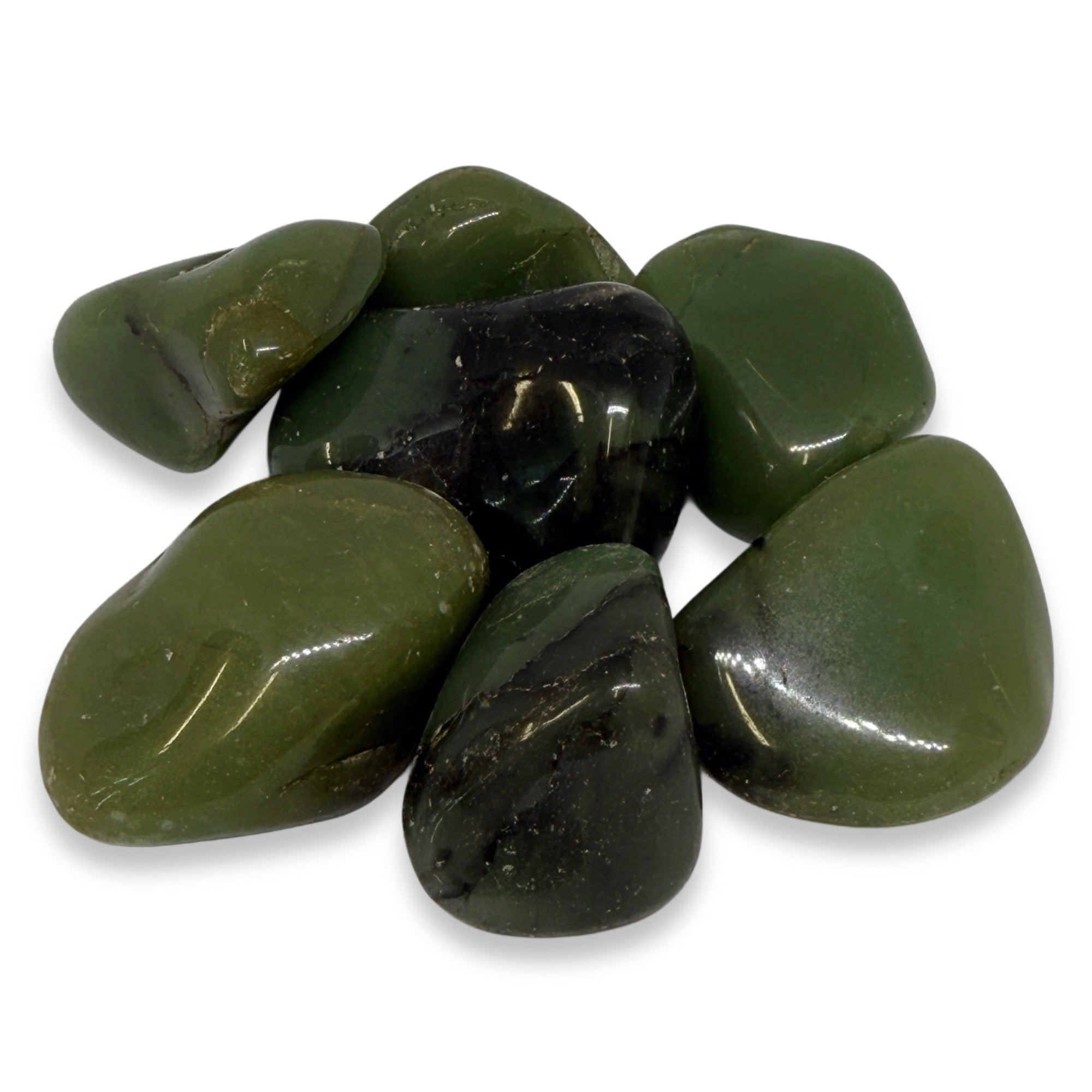 Collection of green and black stones on a white background