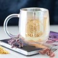 Silver mug with 'You are made of magic' text and butterfly design on a blurred background