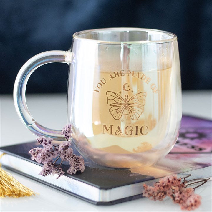 Silver mug with 'You are made of magic' text and butterfly design on a blurred background