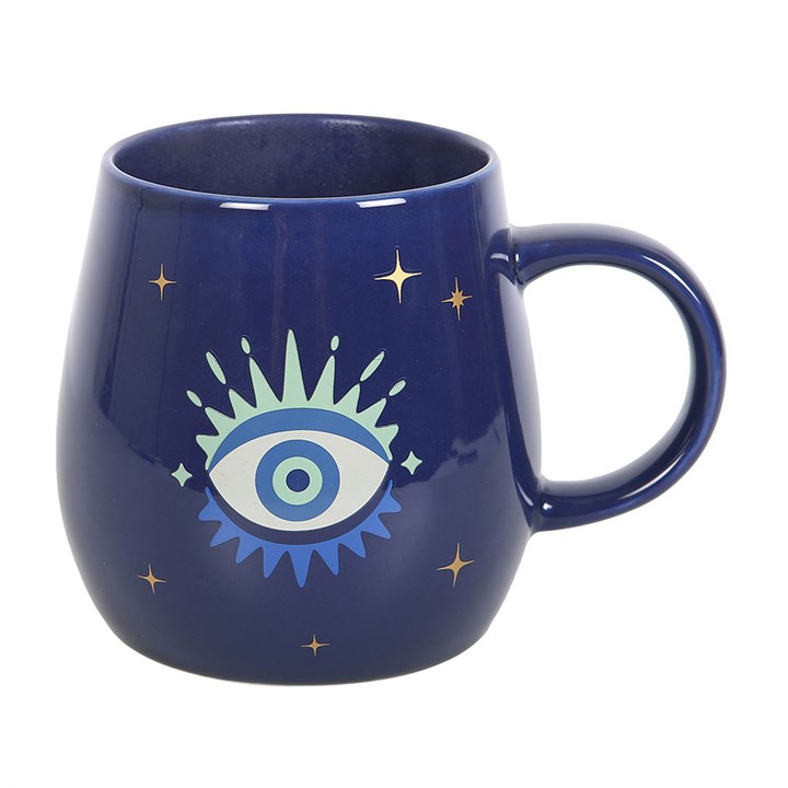 Navy blue mug with eye design and star accents on a white background