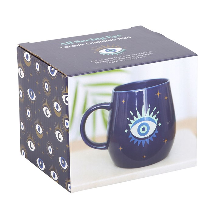 Navy blue mug with eye design in packaging