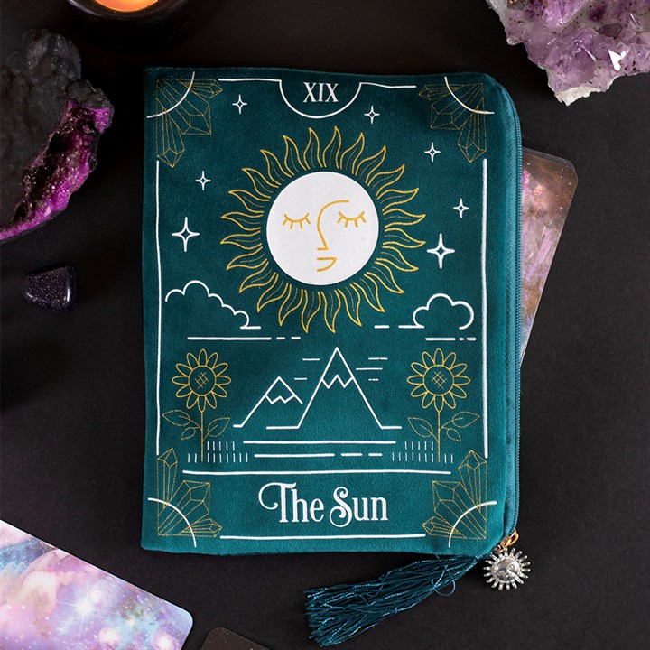 Teal pouch with sun design and 'The Sun' text on a dark background