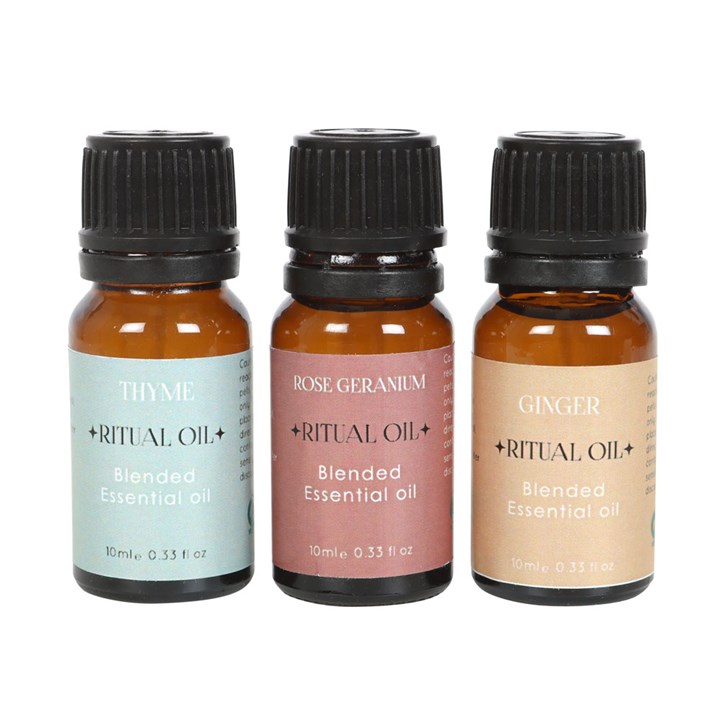 Three essential oil bottles labeled 'Thyme', 'Rose Geranium', and 'Ginger' on a white background.