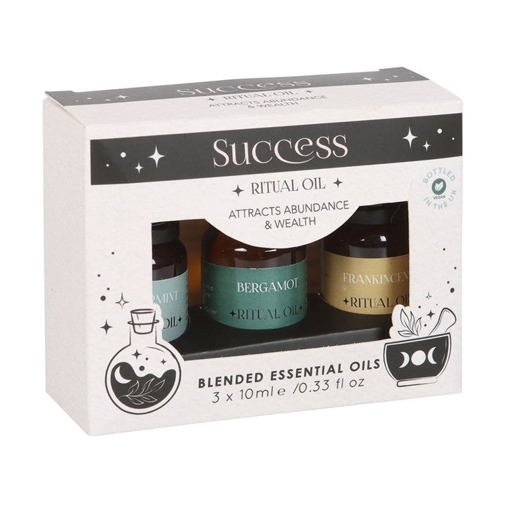 Packaging of blended essential oils with 'Success' theme on a white background