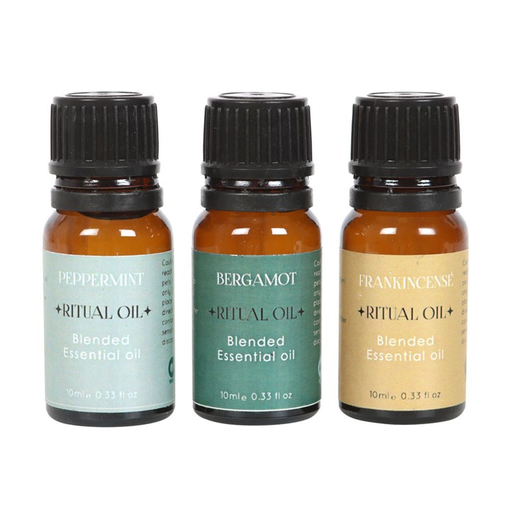 Three essential oil bottles labeled Peppermint, Bergamot, and Frankincense on a white background.