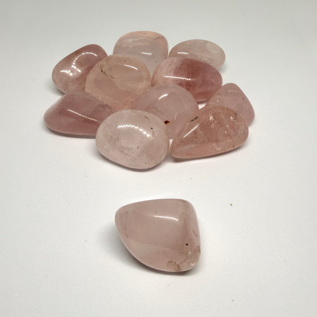 Collection of rose quartz stones on a white background