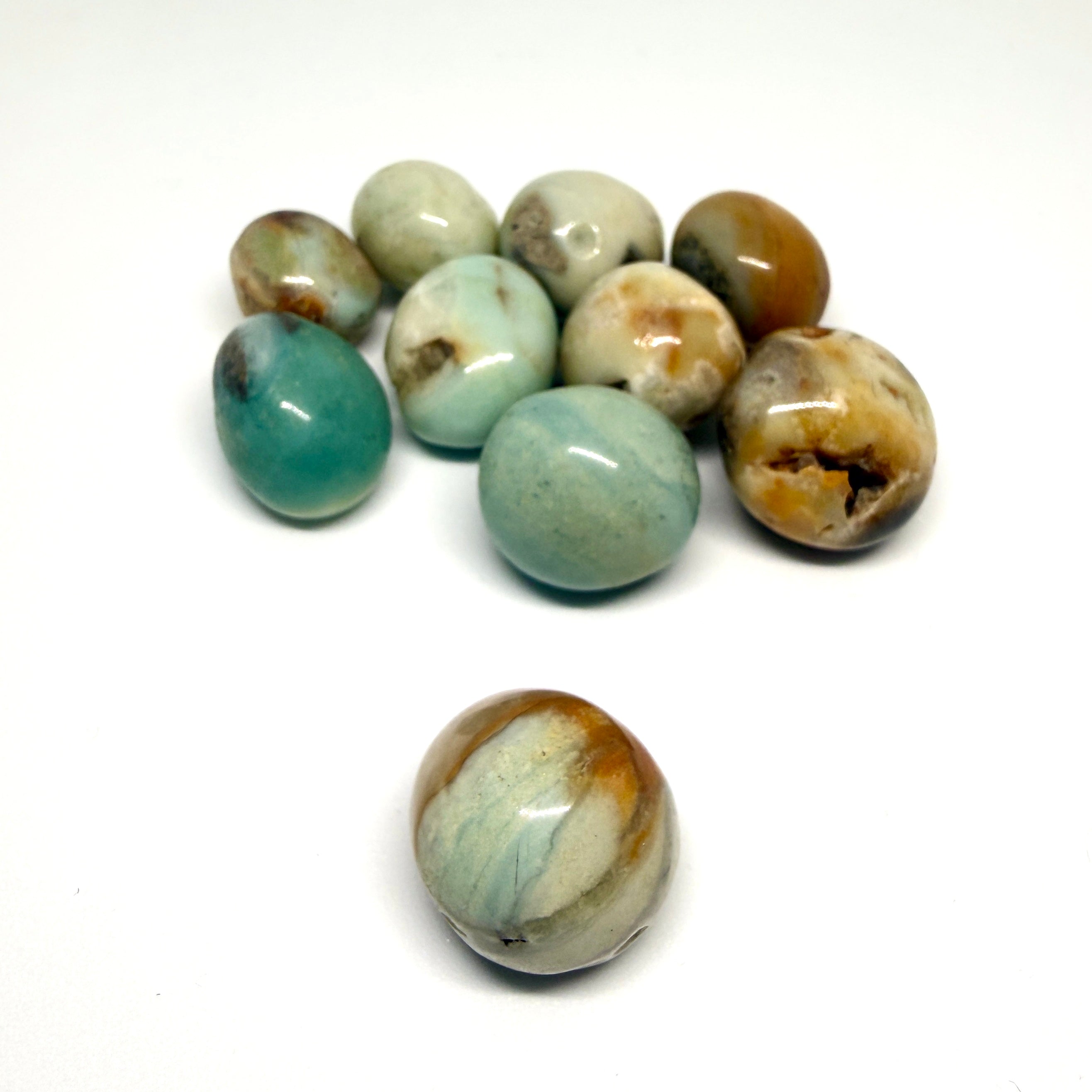 Assorted marbled beads on a white background