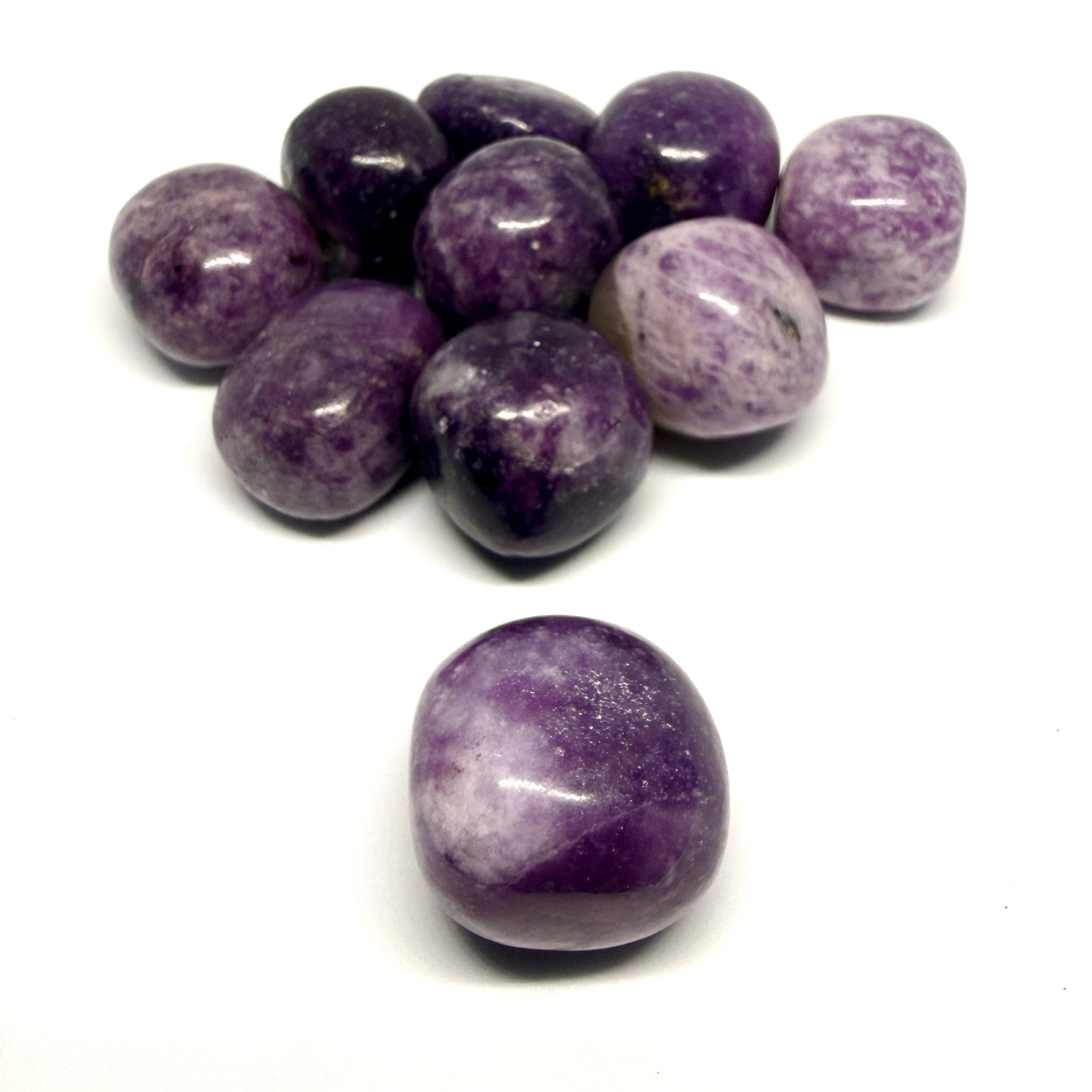 Purple and white speckled stones on a white background