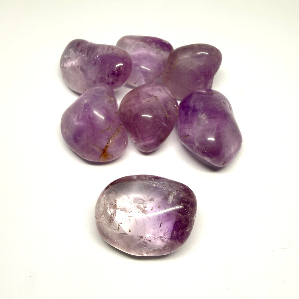 Group of purple amethyst crystals on a white background