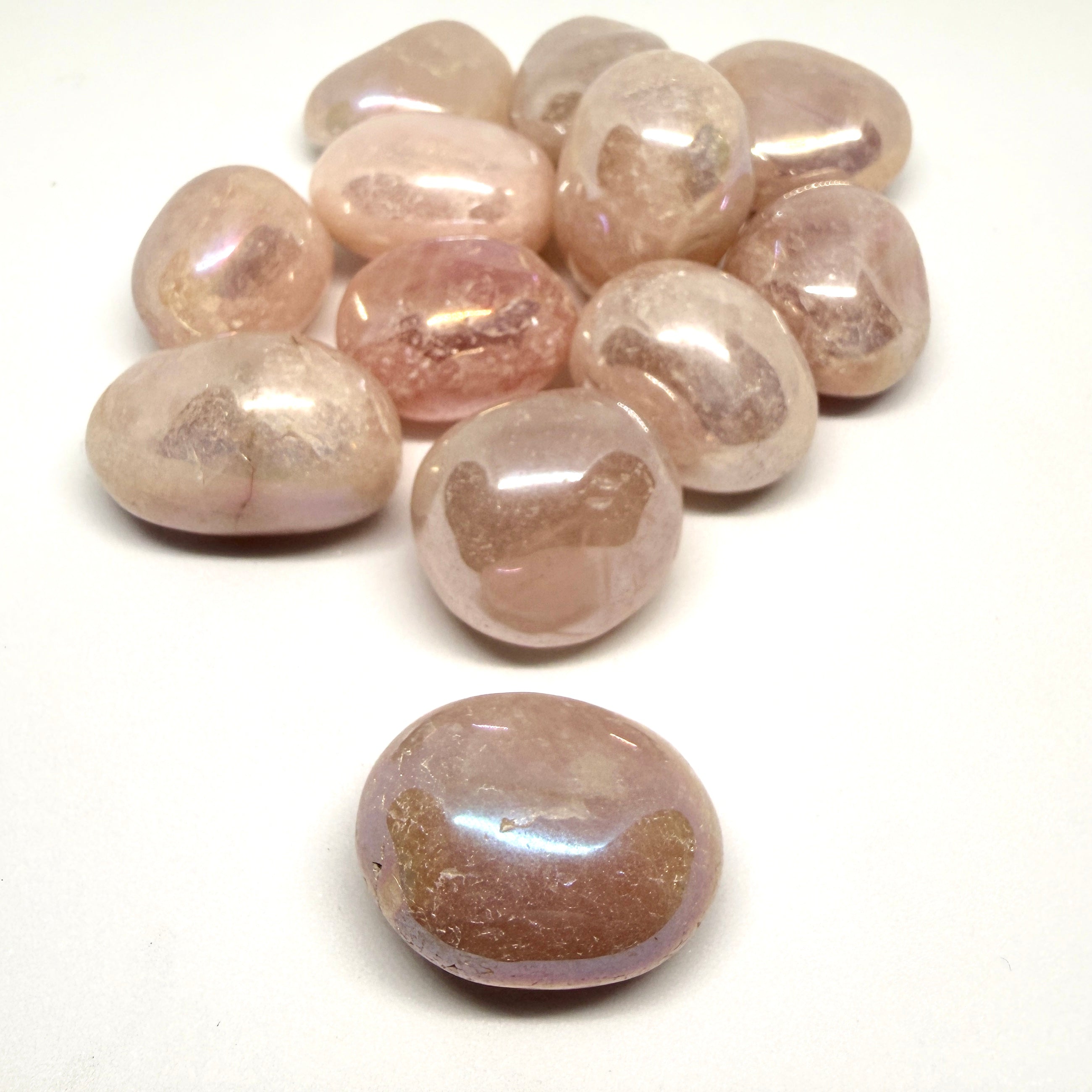 Collection of pink and brown gemstones on a white background