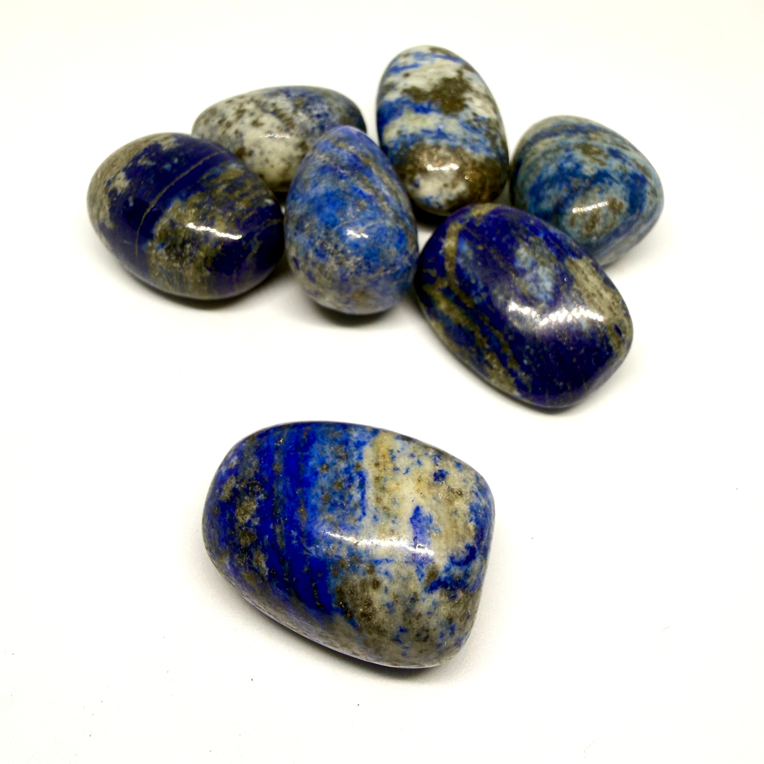 Blue and gray striped stones on a white background