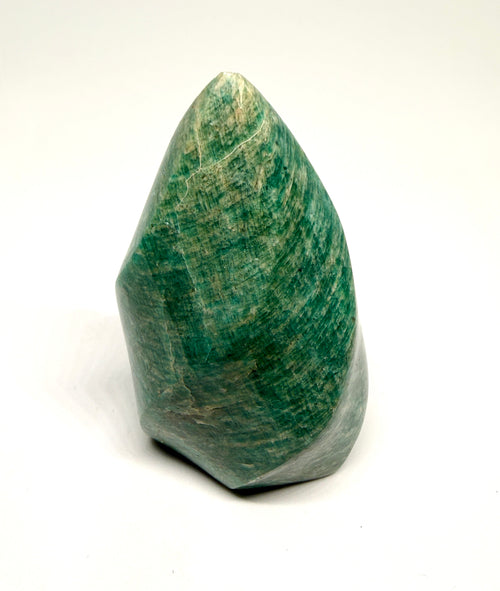 Green stone with a teardrop shape on a white background