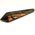 Crystal wand with multicolored patterns on a white background