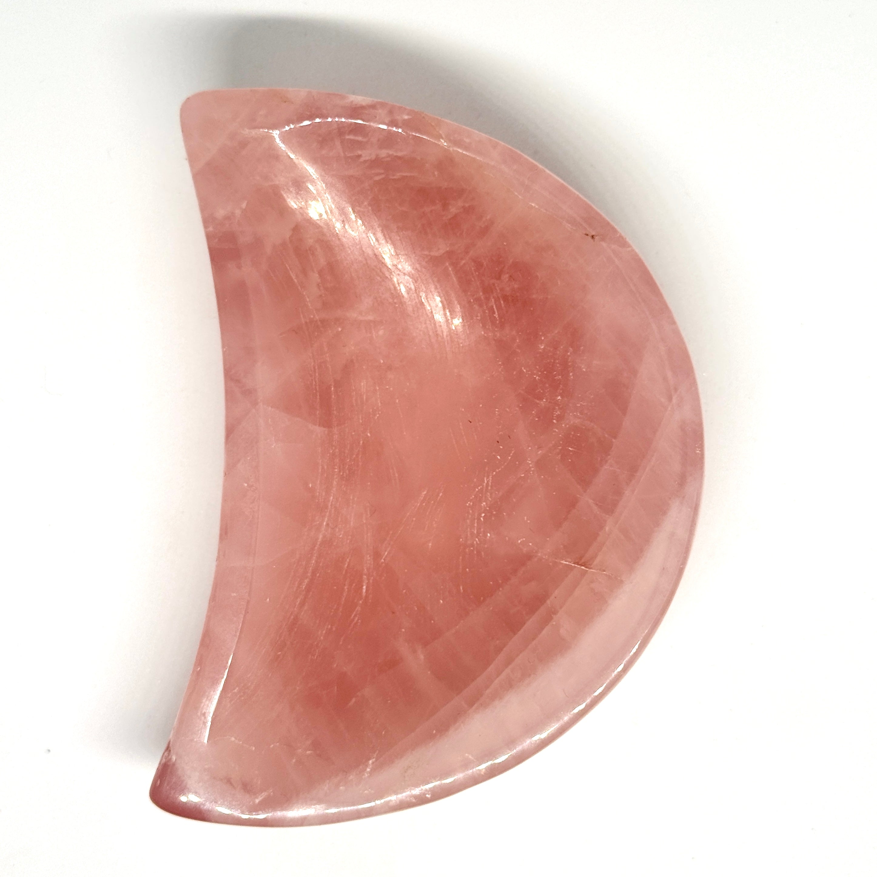 Pink stone with a crescent shape on a white background