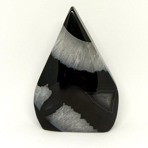 Teardrop-shaped black and gray stone on a white background