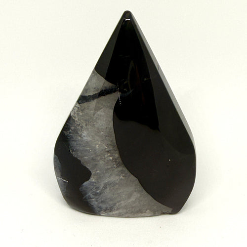 Teardrop-shaped black and gray stone on a white background