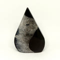Teardrop-shaped black and gray stone sculpture on a white background