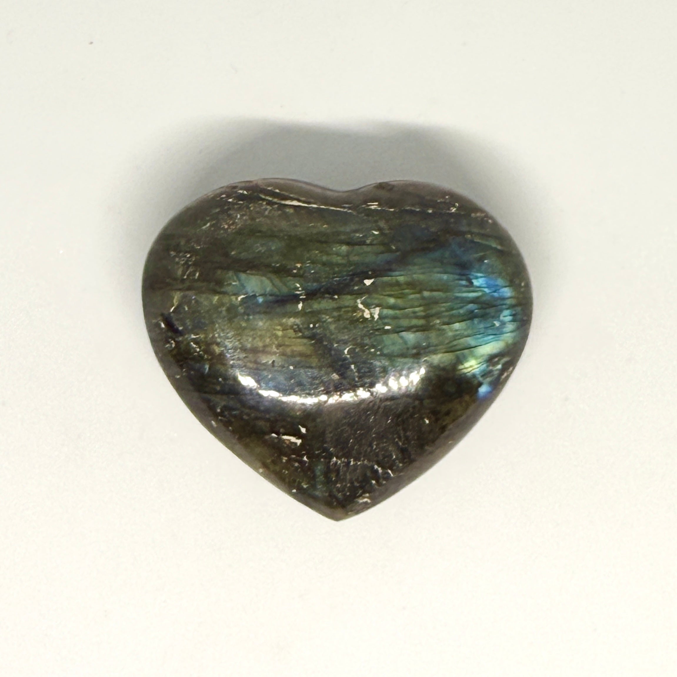 Heart-shaped labradorite stone on a white background
