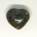 Heart-shaped labradorite stone on a white background