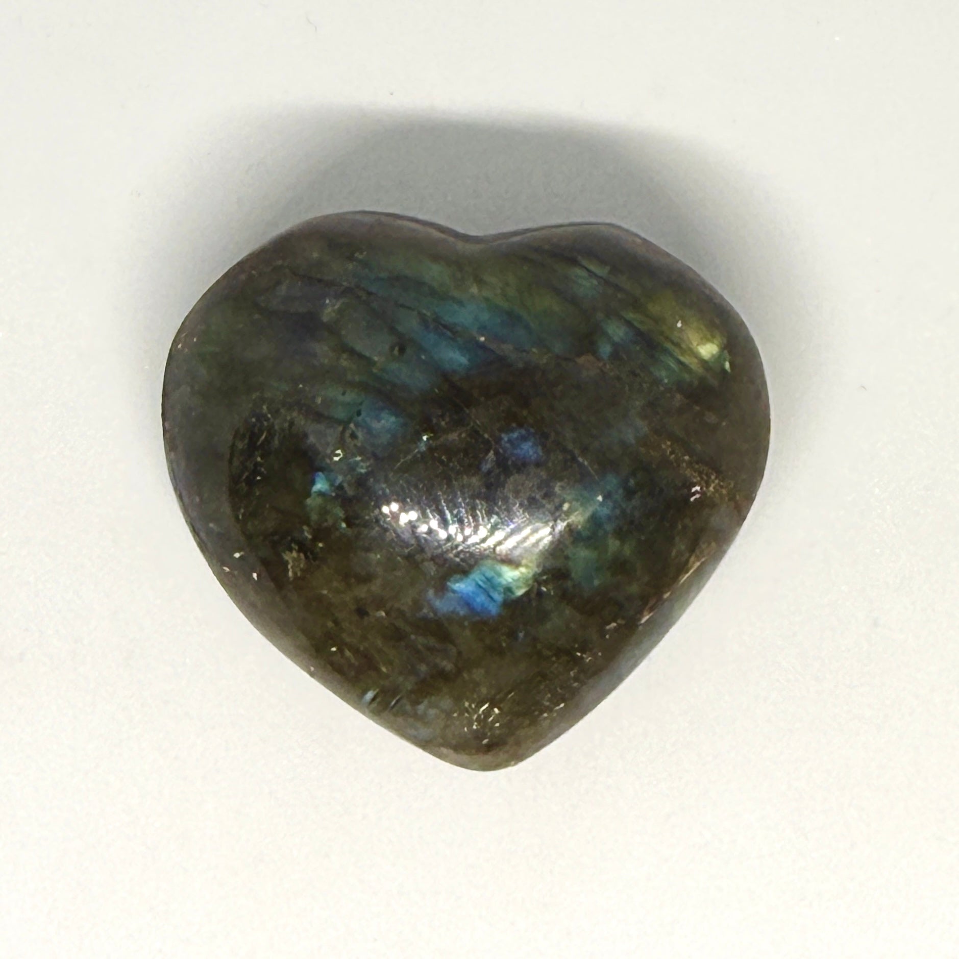 Heart-shaped labradorite stone on a white background