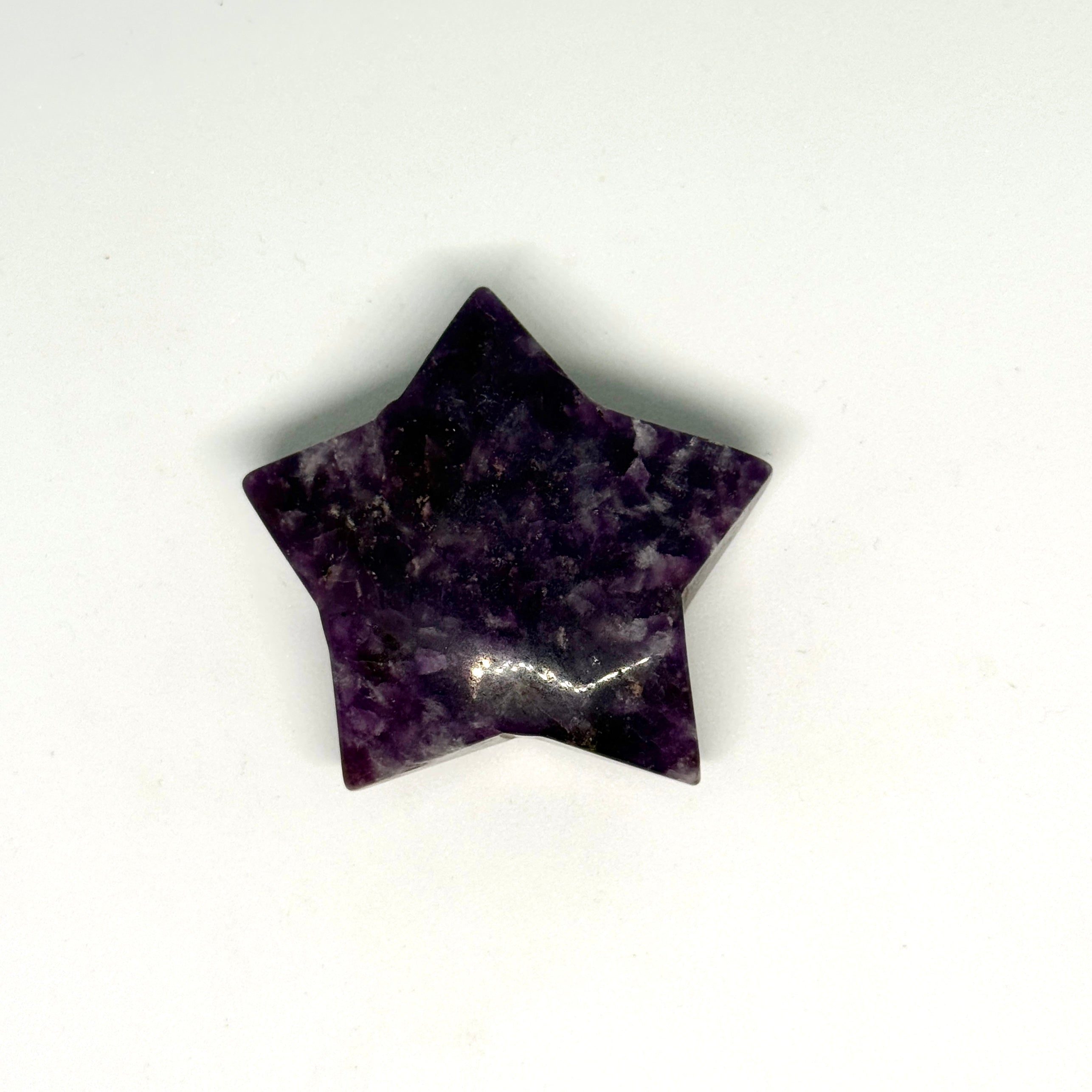 Star-shaped purple stone on a white background