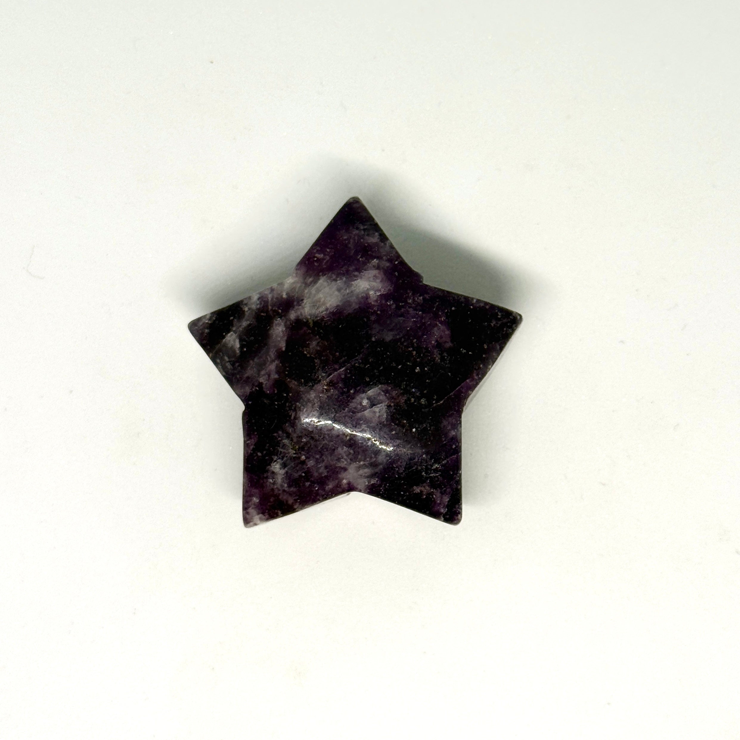 Black star-shaped object on a white background