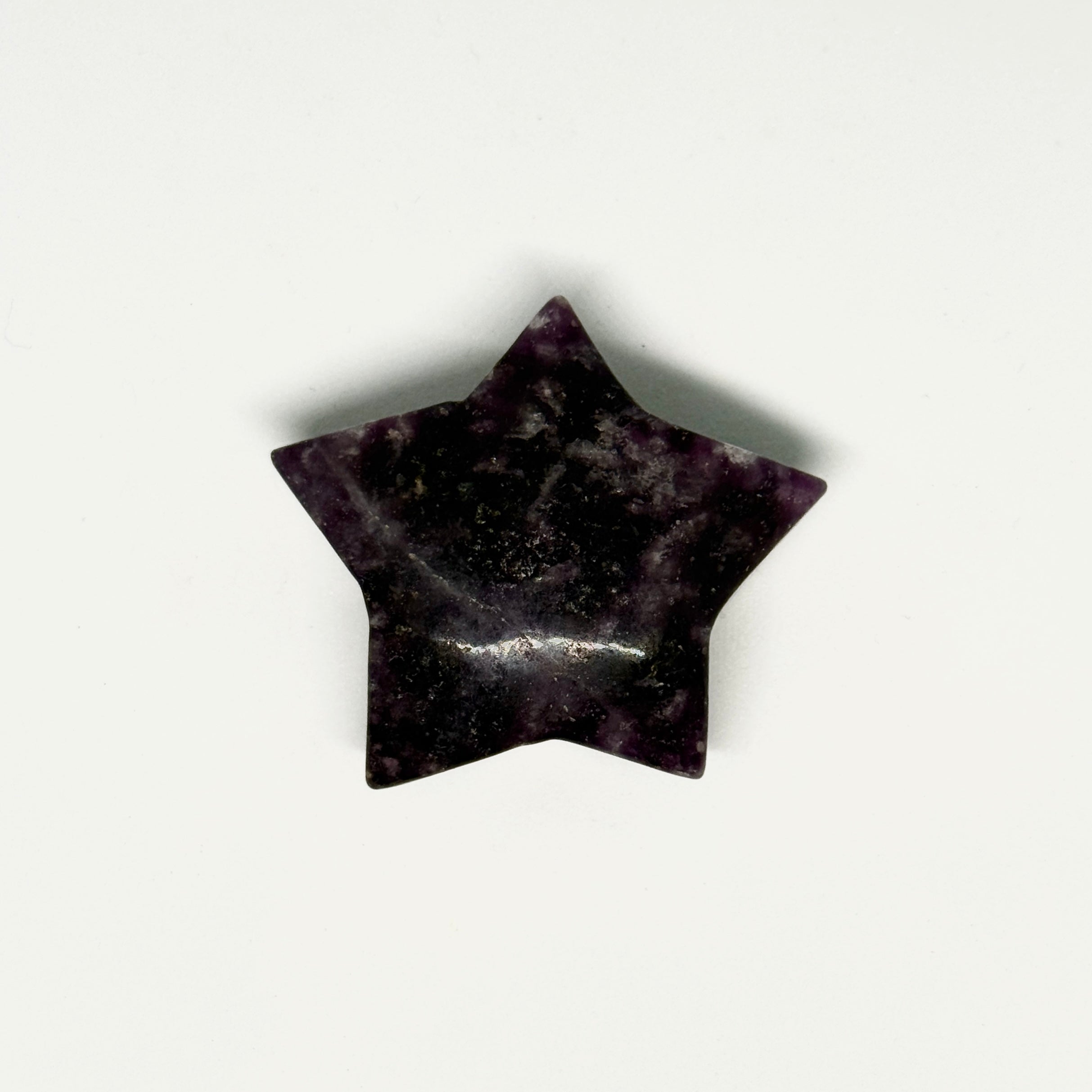 Star-shaped black stone on a white background