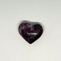 Heart-shaped purple stone on a white background