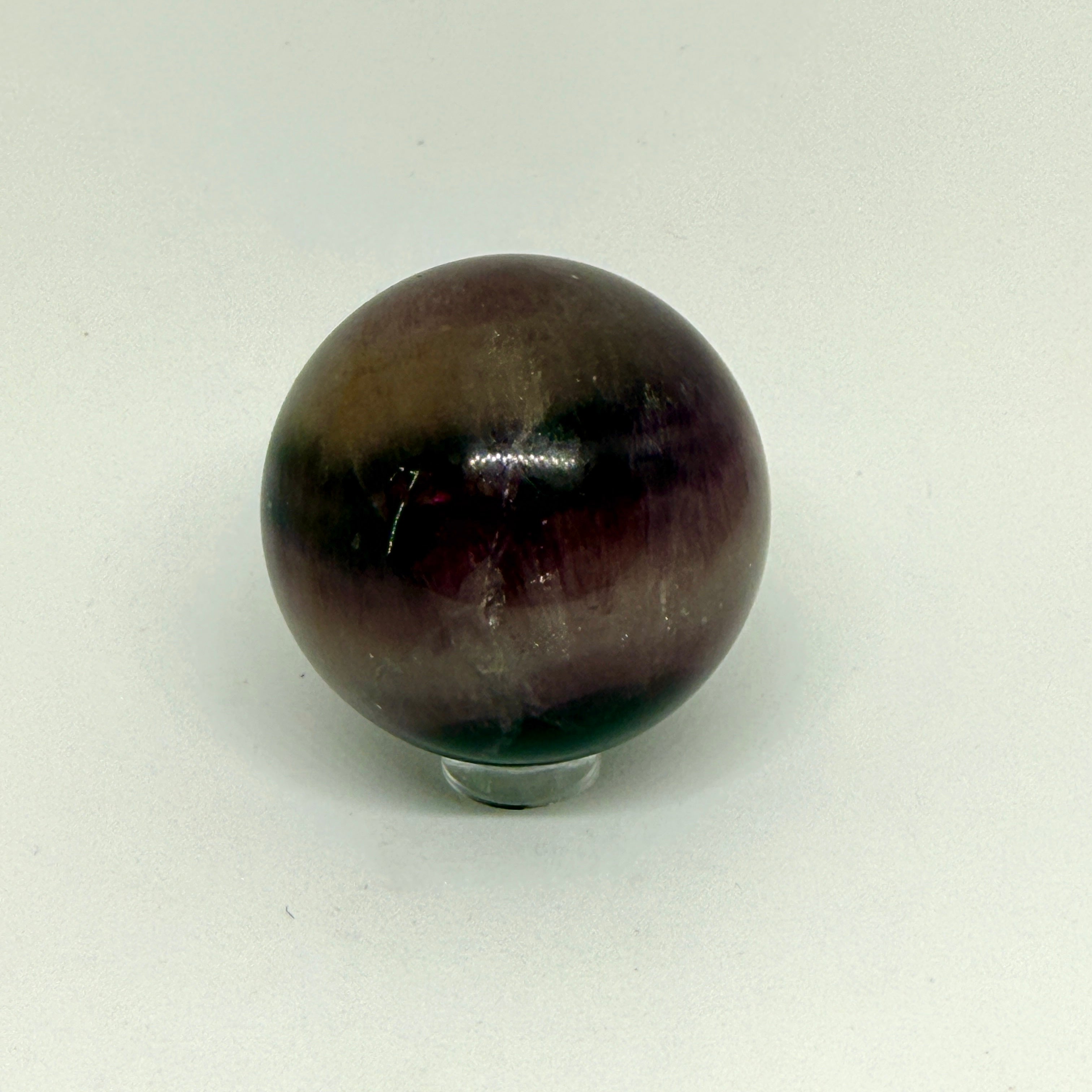 Brown and black marbled sphere on a white background
