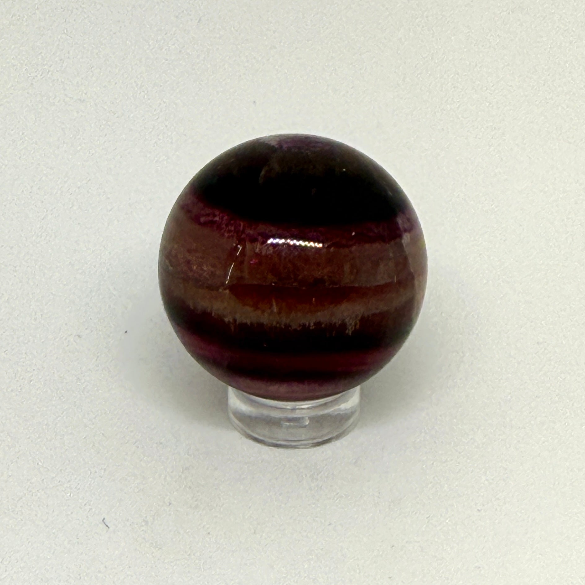 Brown striped sphere on a white background