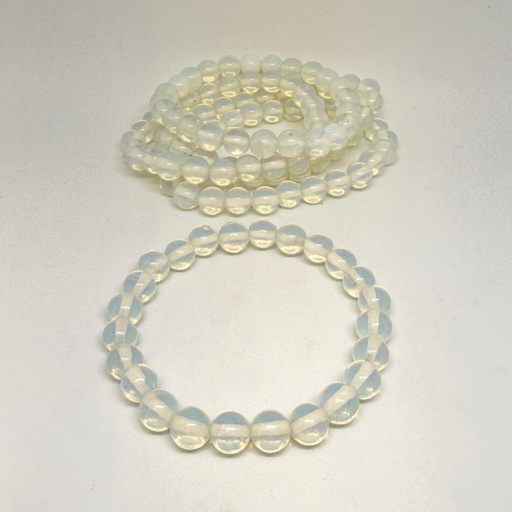 Two strands of light-colored beads on a white background