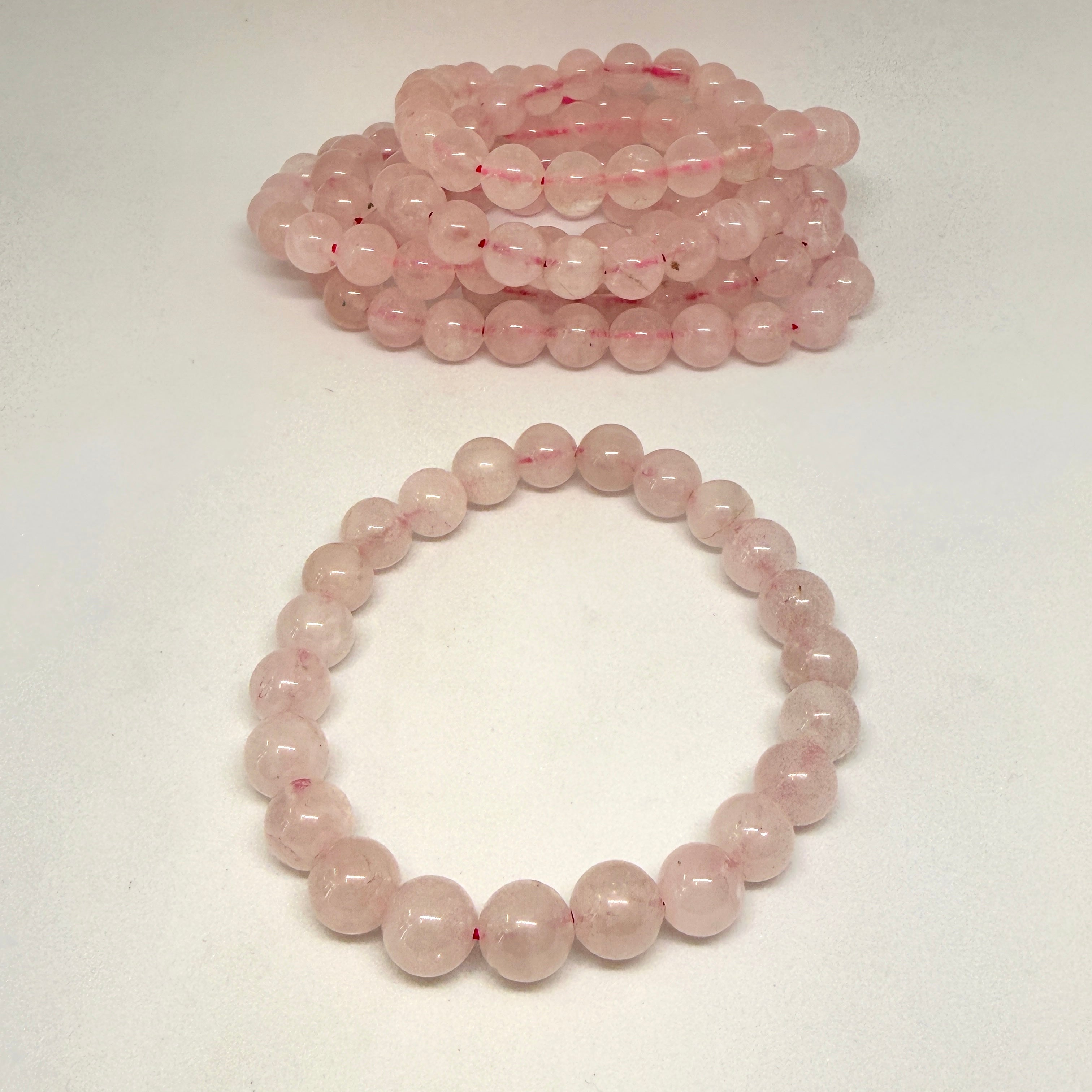 Pink beaded bracelet on a white background