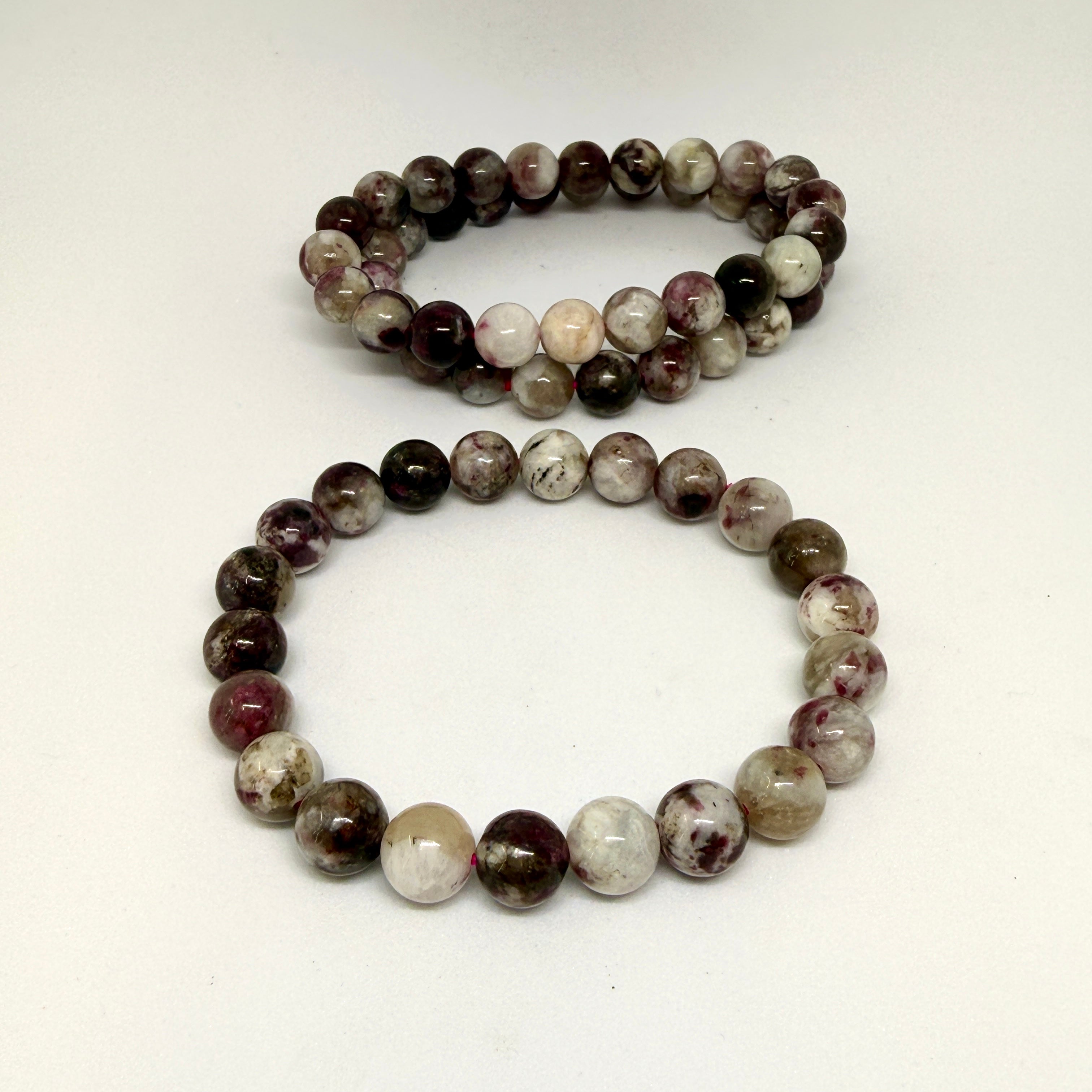 Two beaded bracelets on a white background