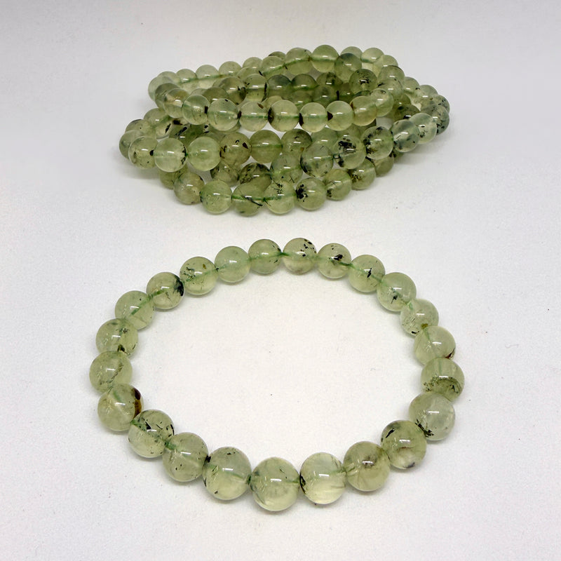 Green bead necklace on a white background