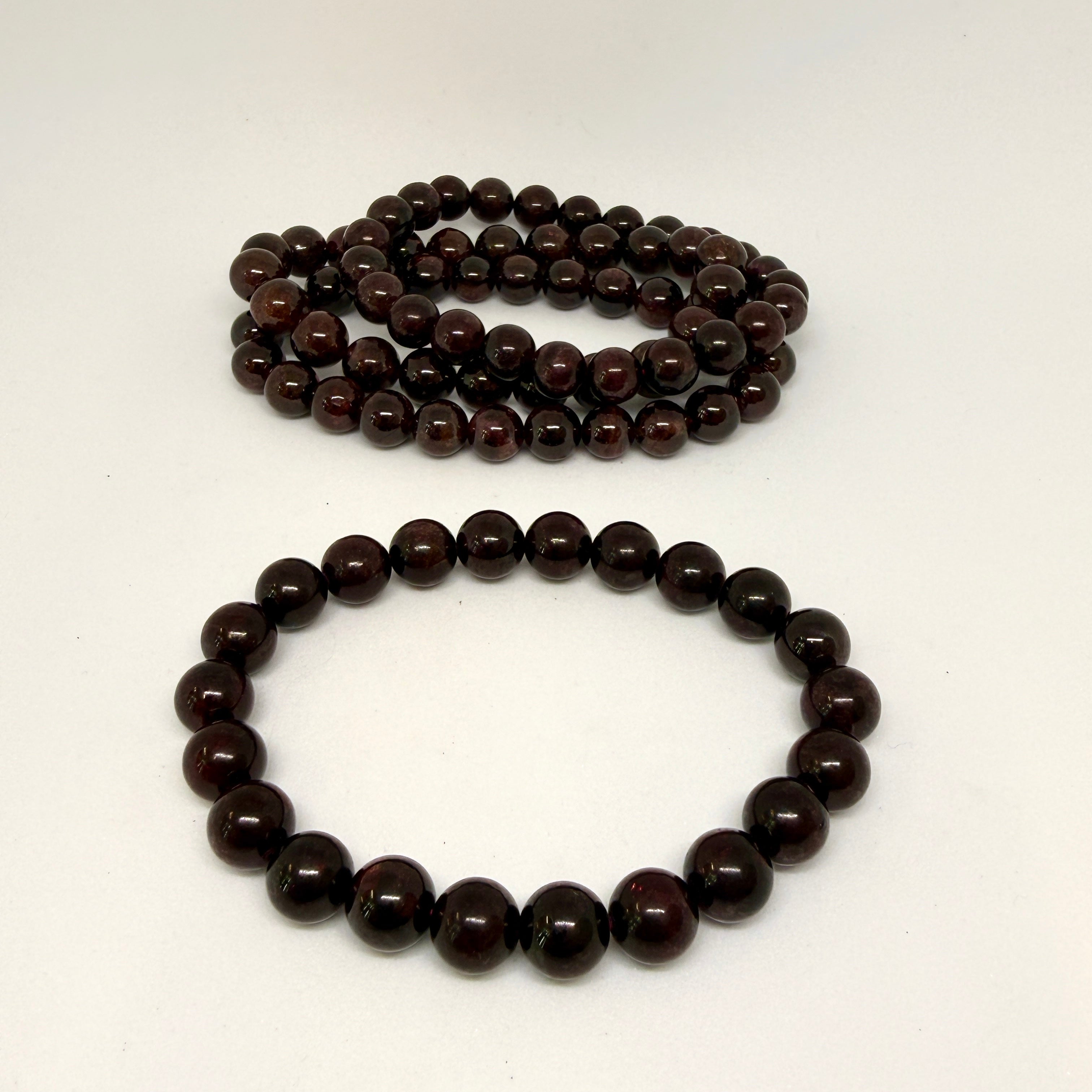 Brown beaded necklace and bracelet on a white background