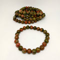 Two unakite beaded bracelets on a white background